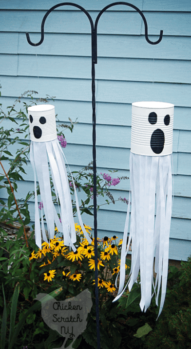 tin can ghosts hanging from pole