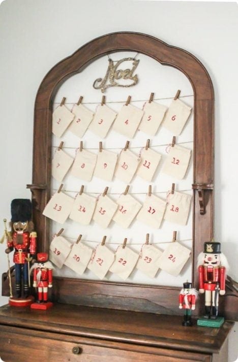 DIY upcycled mirror into reusable advent calendar with hanging pouches