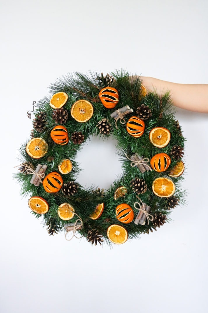 DIY citrus and pine cone wreath