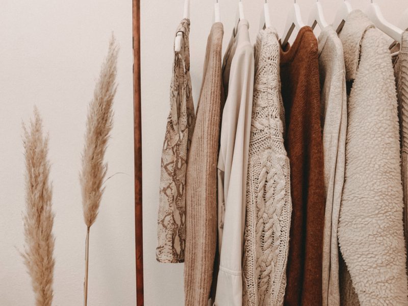 beige and brown clothing handing on rack