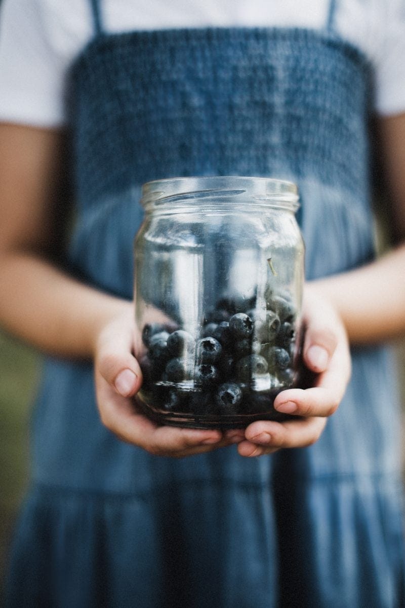 blueberries in glass jar to help reduce food waste