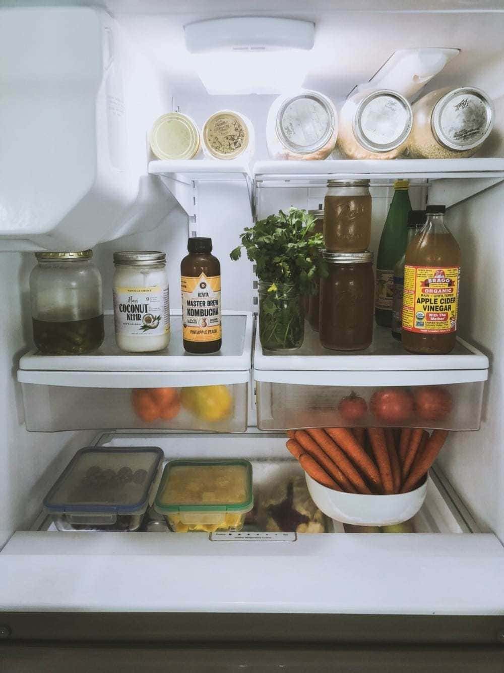 fridge filled with food in repurposed glass jars and containers