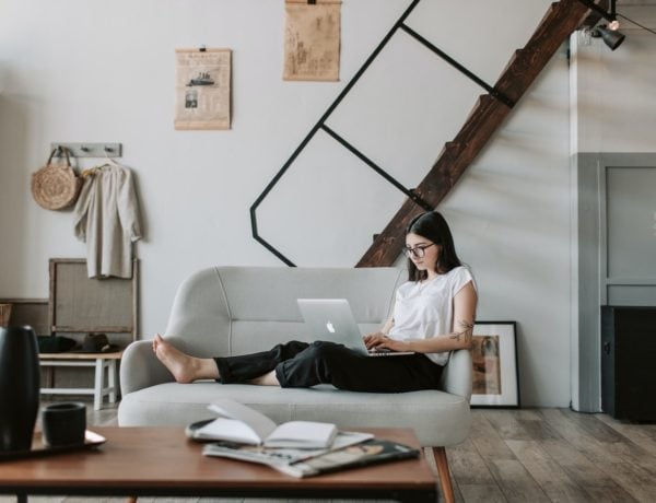 woman on couch shopping online
