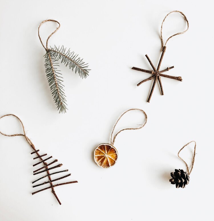 natural Christmas tree ornaments made with trigs, evergreen branches, dried orange and a pinecone