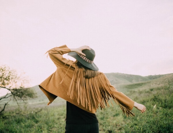 woman facing nature landscape