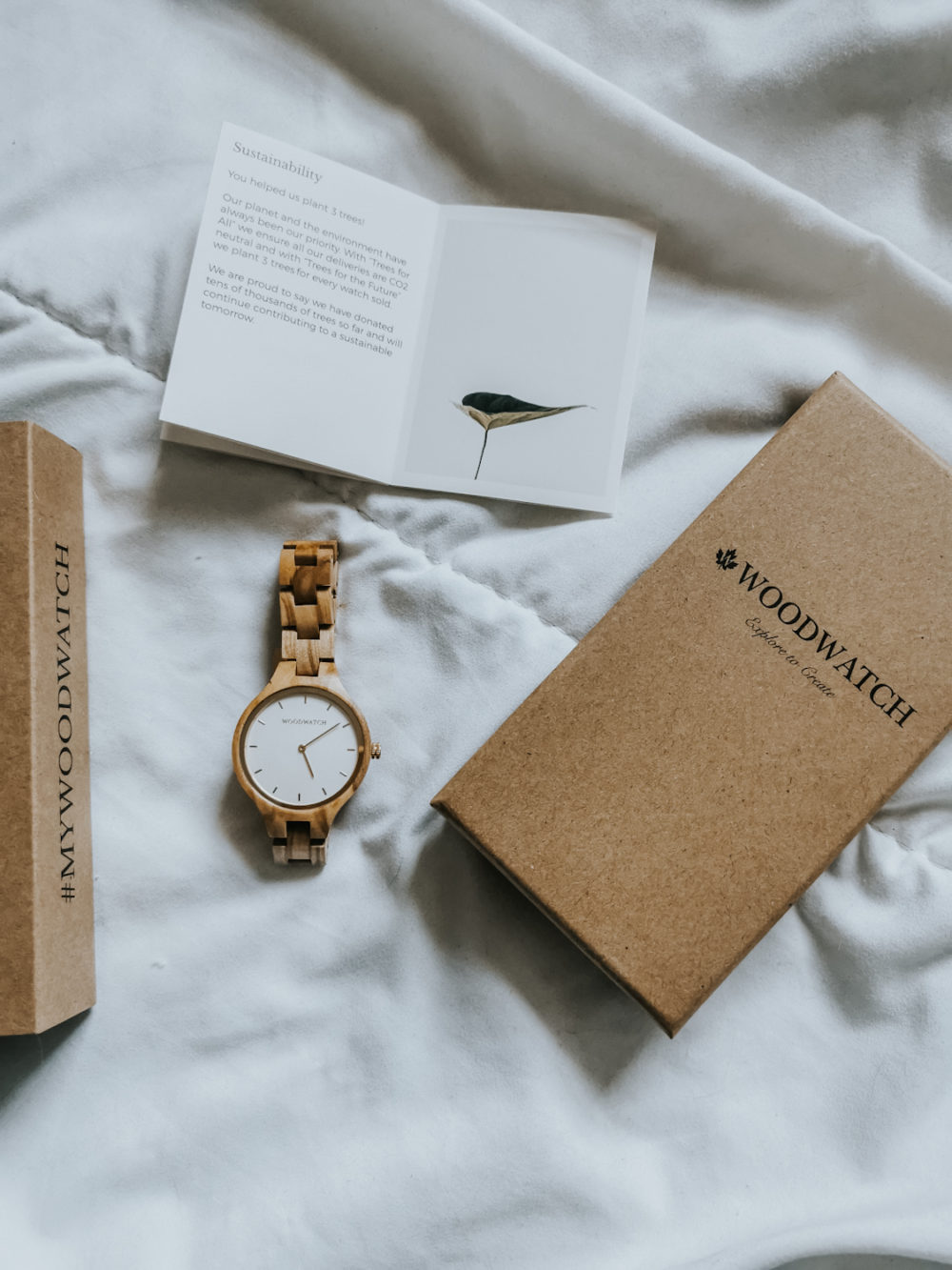 wooden watch by WoodWatch on white background with cardboard packaging