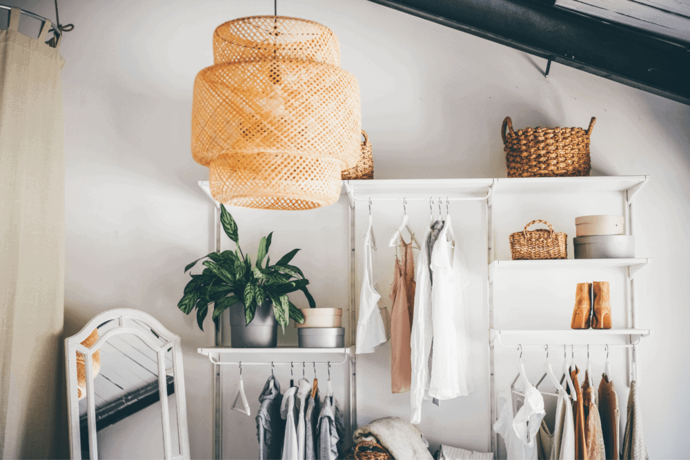 minimal open wardrobe with shirts and sweaters hanging