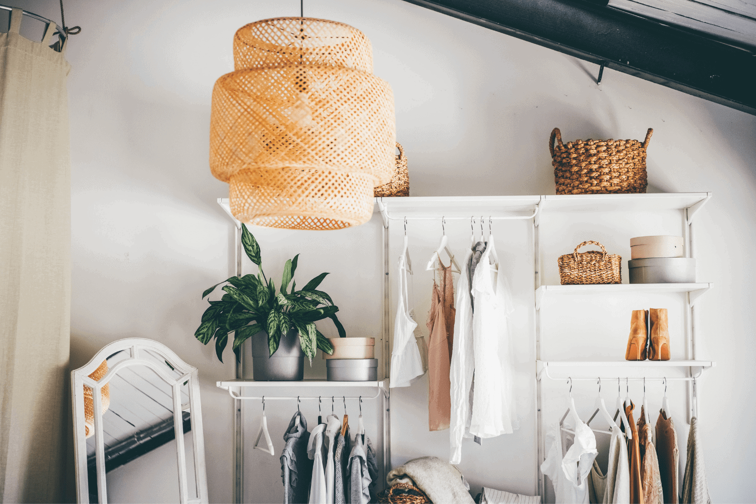 clothes hanging on wardrobe hangers in room