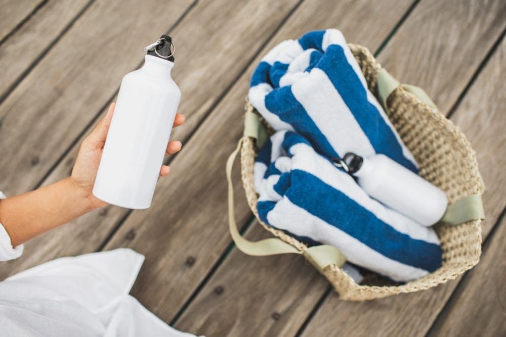 hand holding reusable water bottle