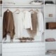 sustainable capsule wardrobe with shirts hanging, accessories and purses on shelves
