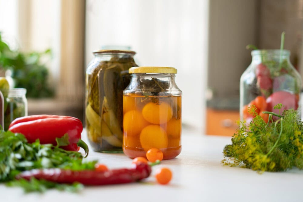 repurposed glass jars with cucumbers and eggs pickling 