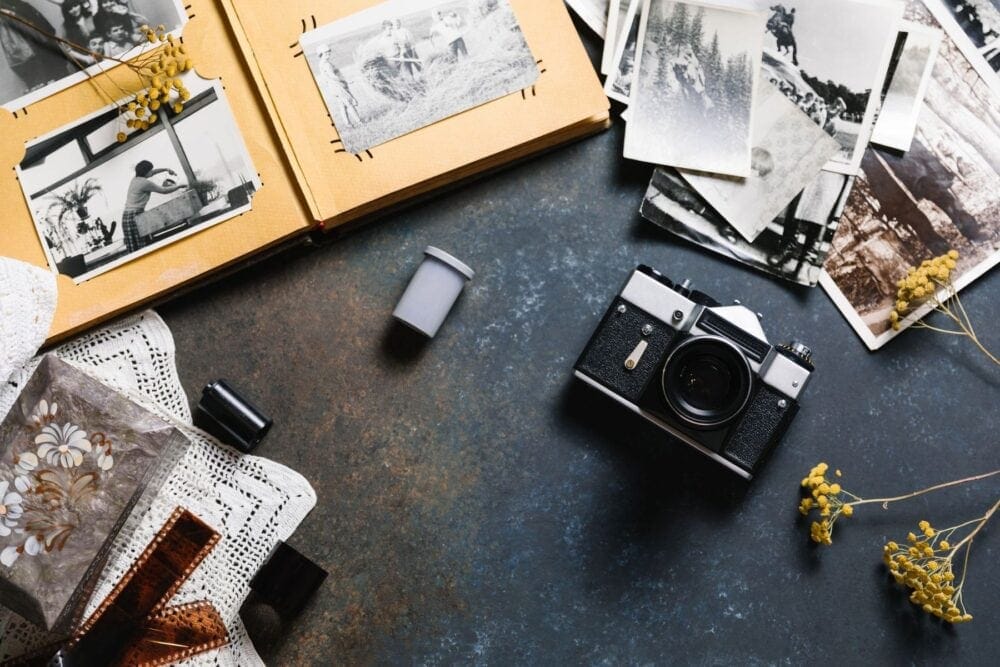 mindful scrapbook with photos on table with camera and flowers