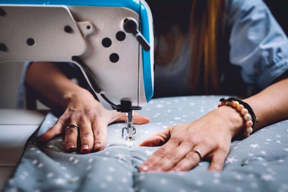 woman working on sewing machine 