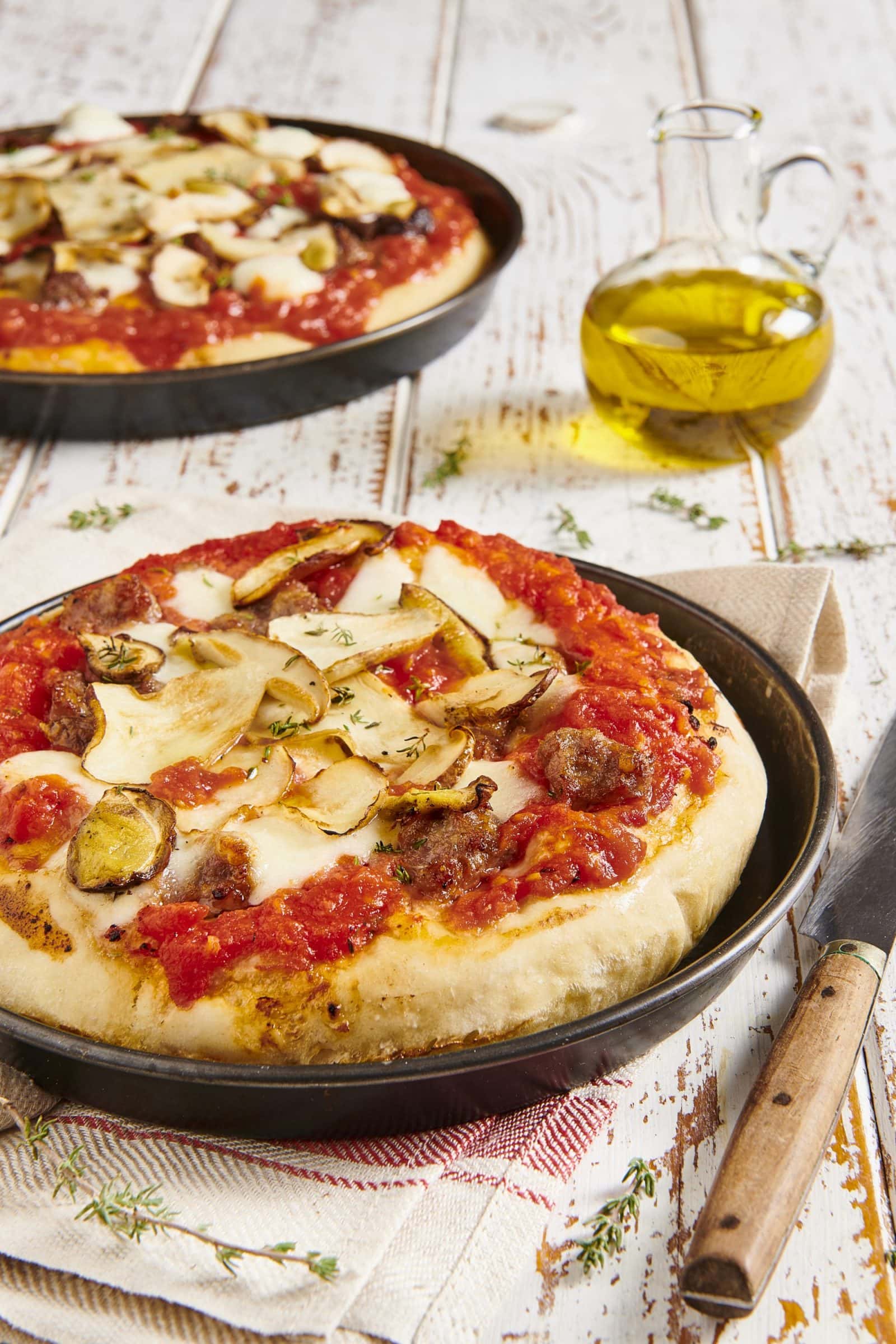 Deep pan Pizza with Finely Chopped Tomatoes, sausage and porcini mushrooms