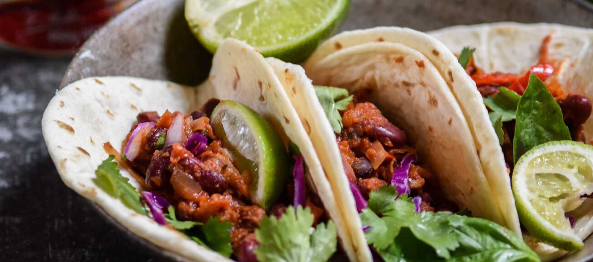 Chilli bean tacos with chopped tomatoes