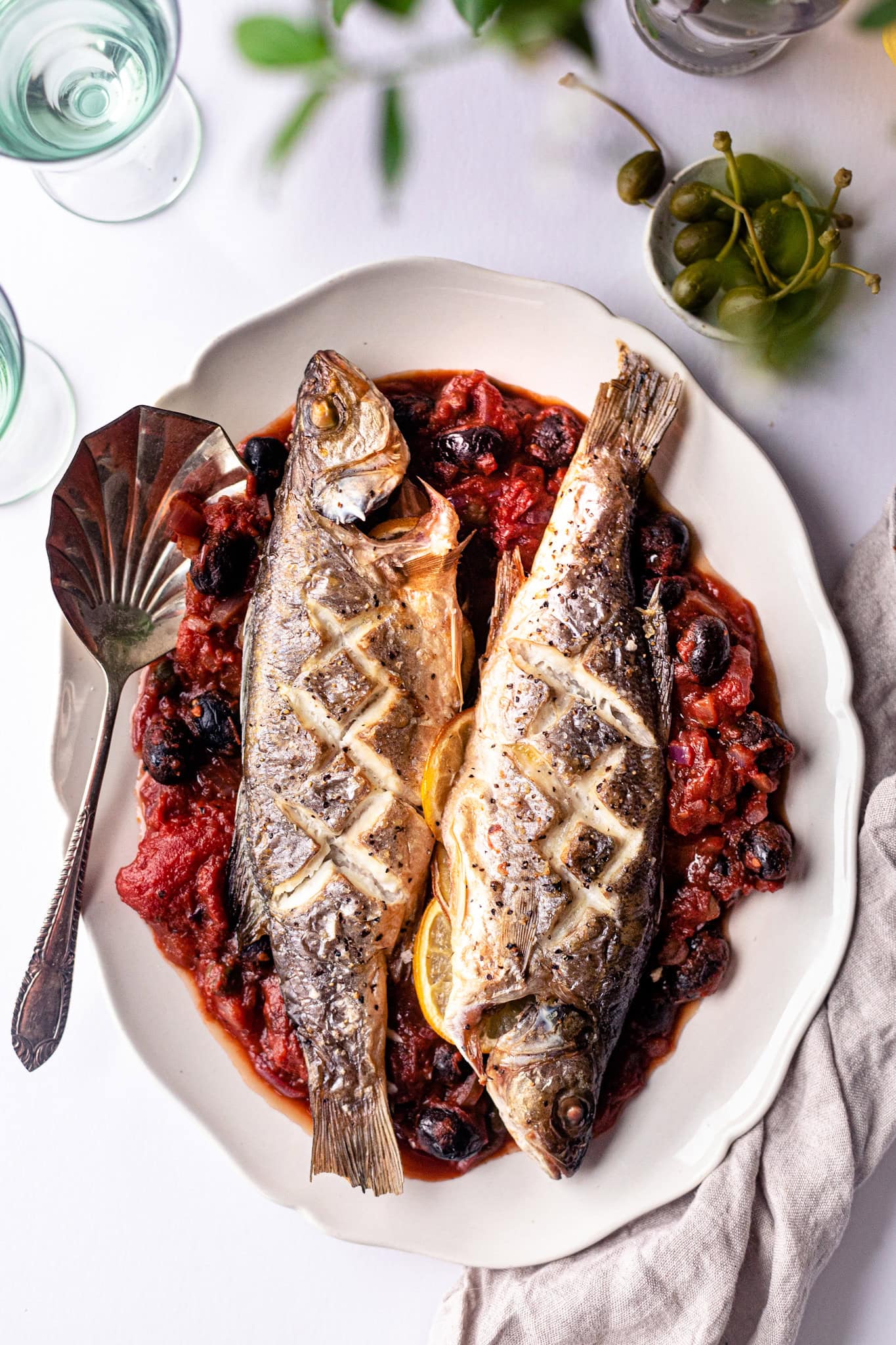 Baked whole sea bass with tomato sauce