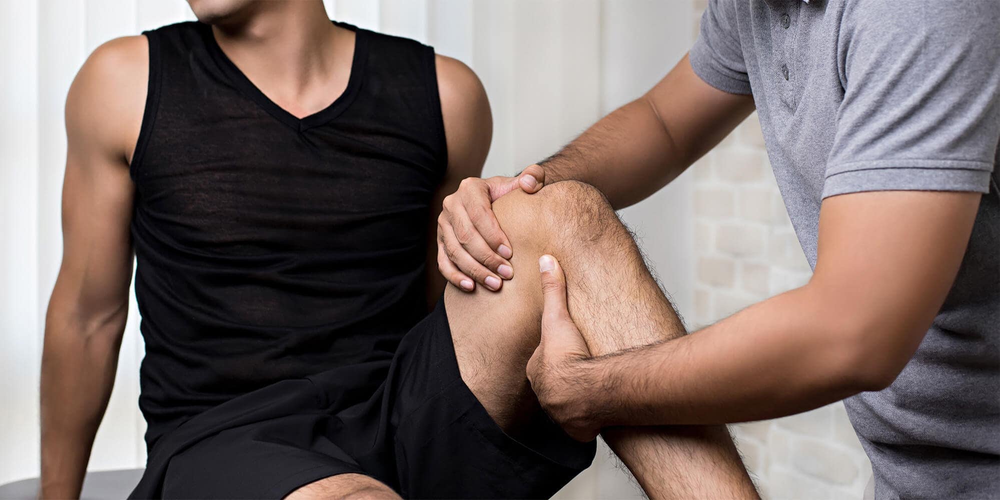 Physiotherapist aiding patient in orthopedic rehabilitation session