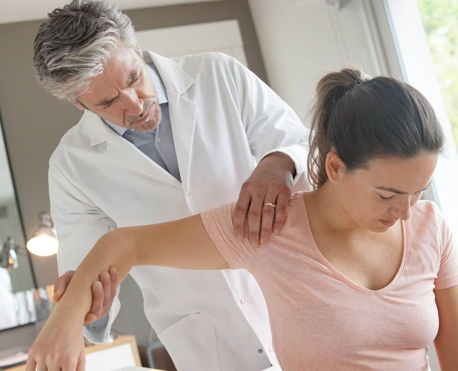 Doctor examining should injury