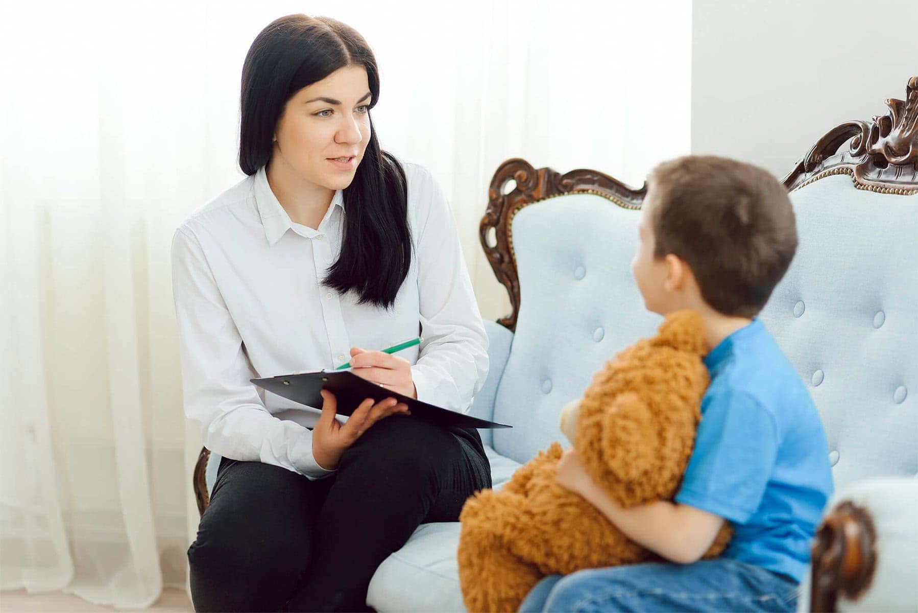Counsellor with child in treatment session