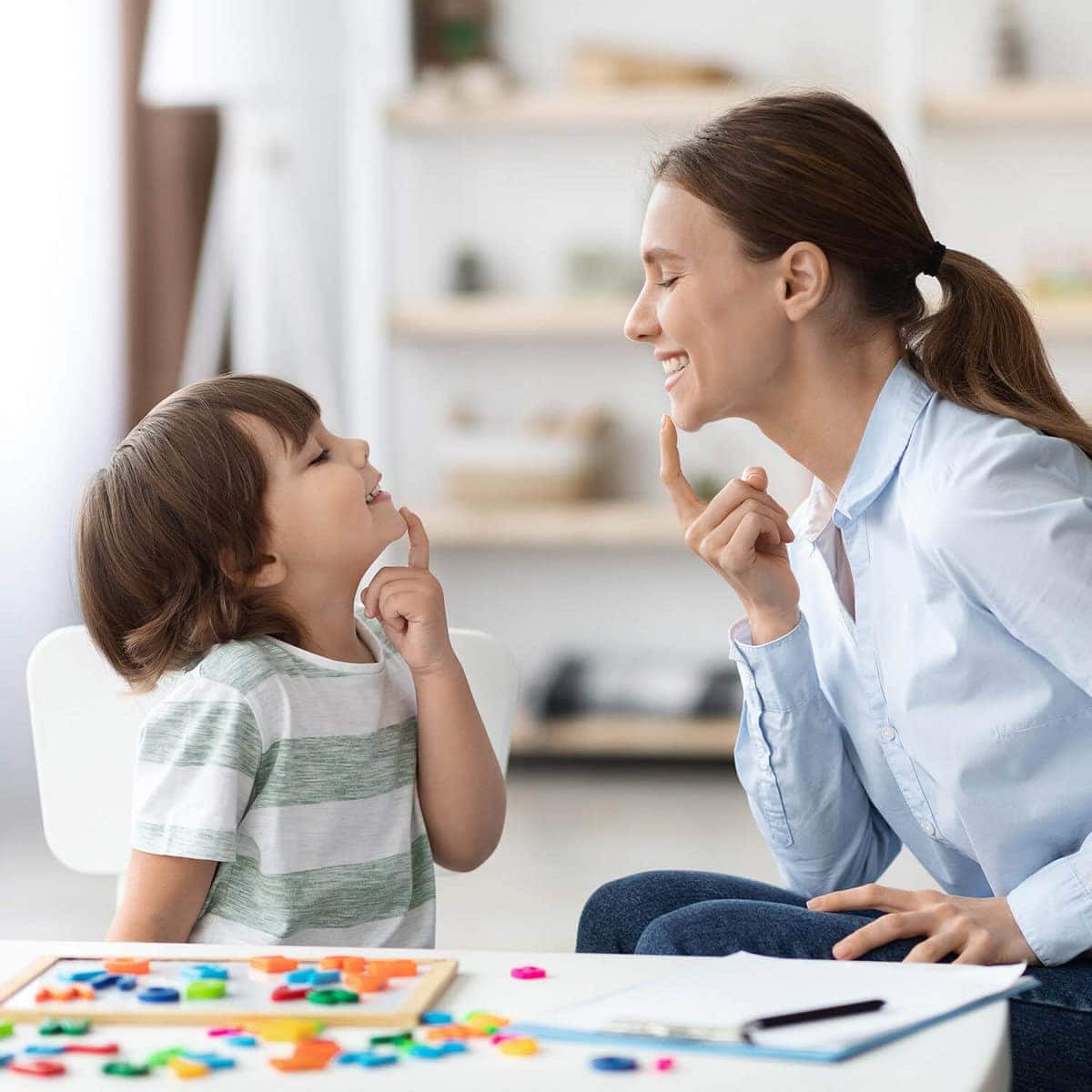 Child receiving speech therapy from a professional therapist