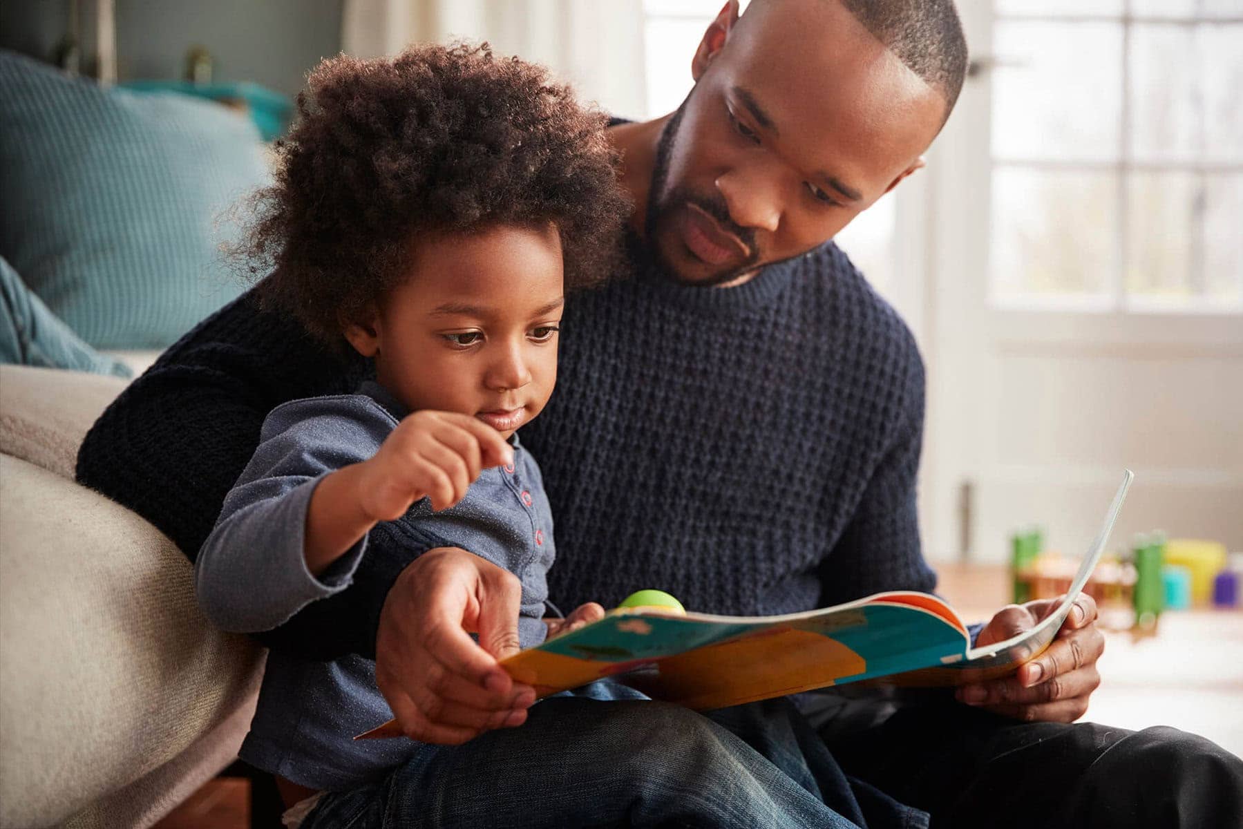 Father and child reading a book