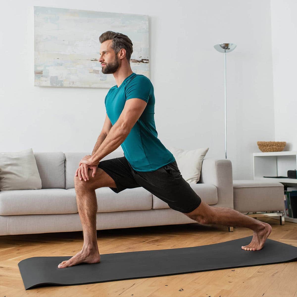 Man practicing yoga at home via online program