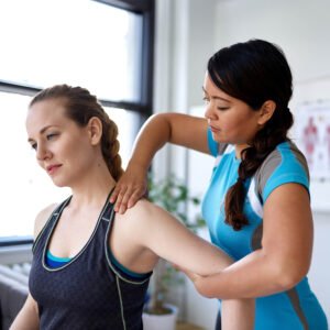 Smiling therapist offering physiotherapy member rewards brochure