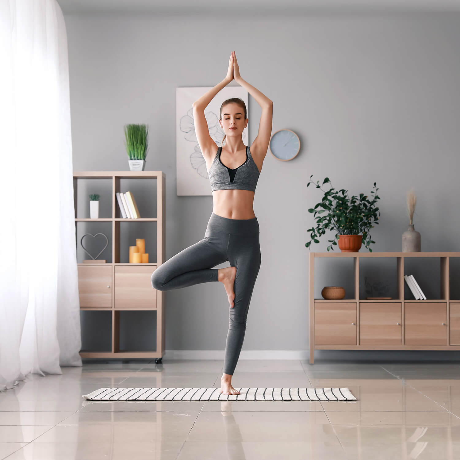 Woman practicing yoga at home with a serene expression