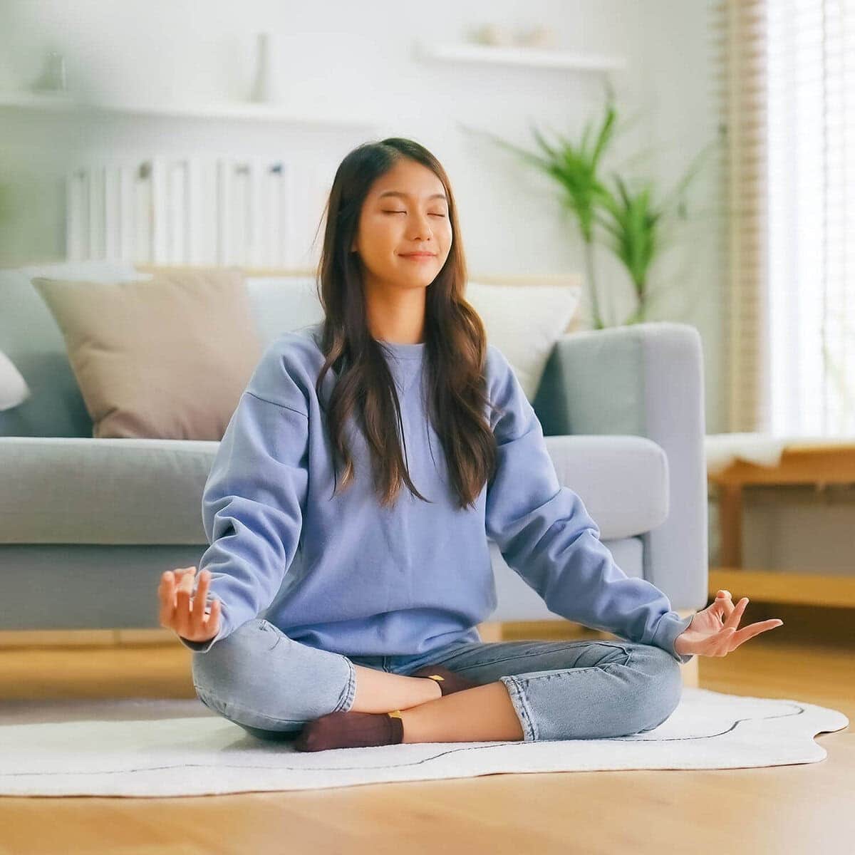 Woman practicing yoga therapy in serene studio setting