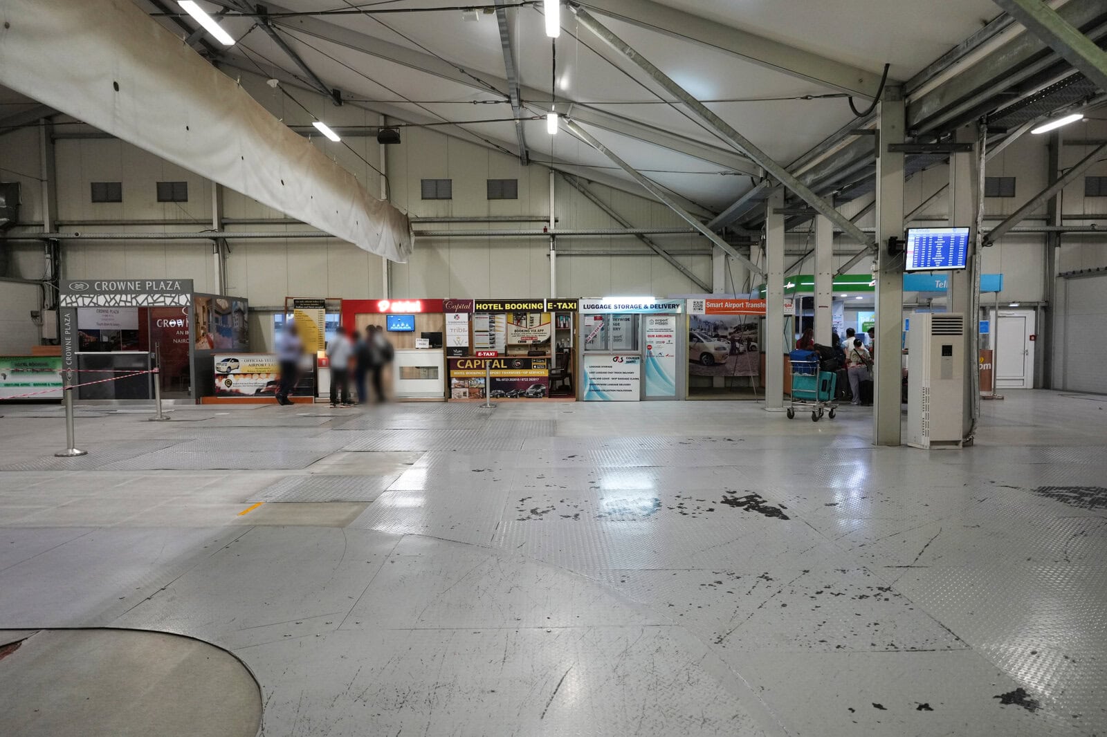 ナイロビ・ジョモ・ケニヤッタ国際空港の到着エリアに並ぶホテル予約や送迎サービスのカウンター