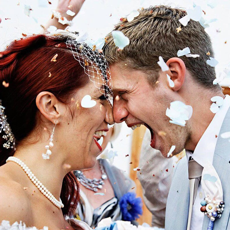 wedding couple celebrating with confetti
