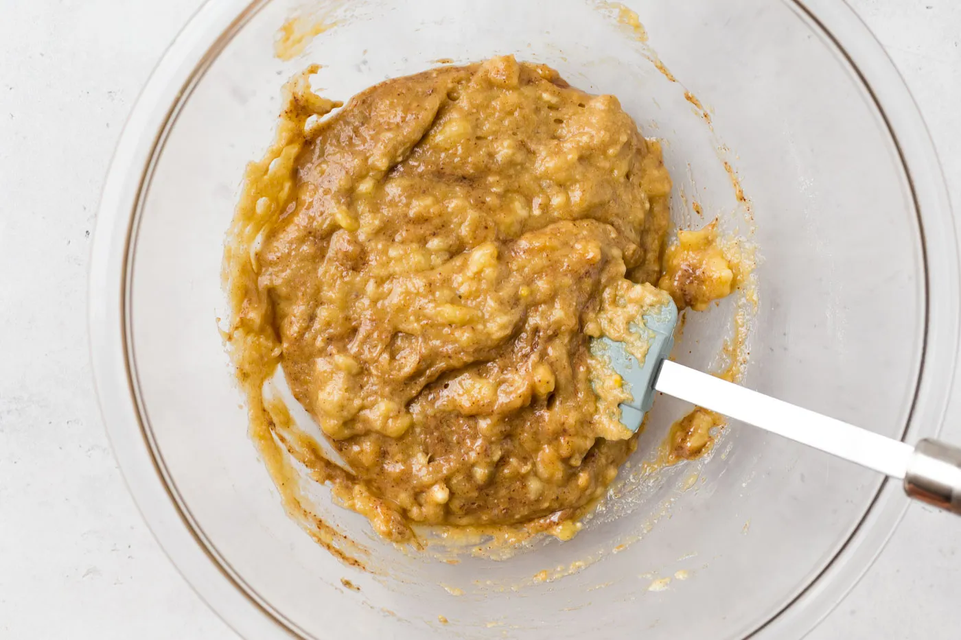 batter in glass mixing bowl with baking spatula