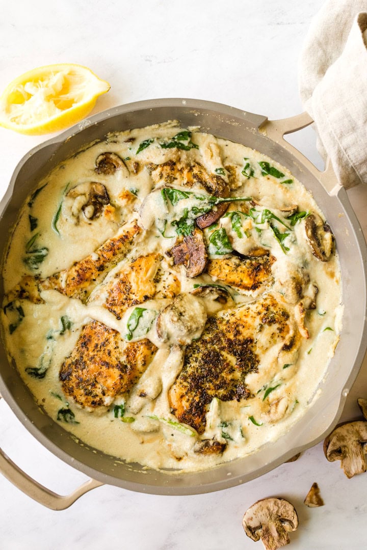 an overhead shot of this creamy and healthy Chicken Florentine Skillet recipe in an oven-safe pan Paleo, Dairy-Free, and Whole30