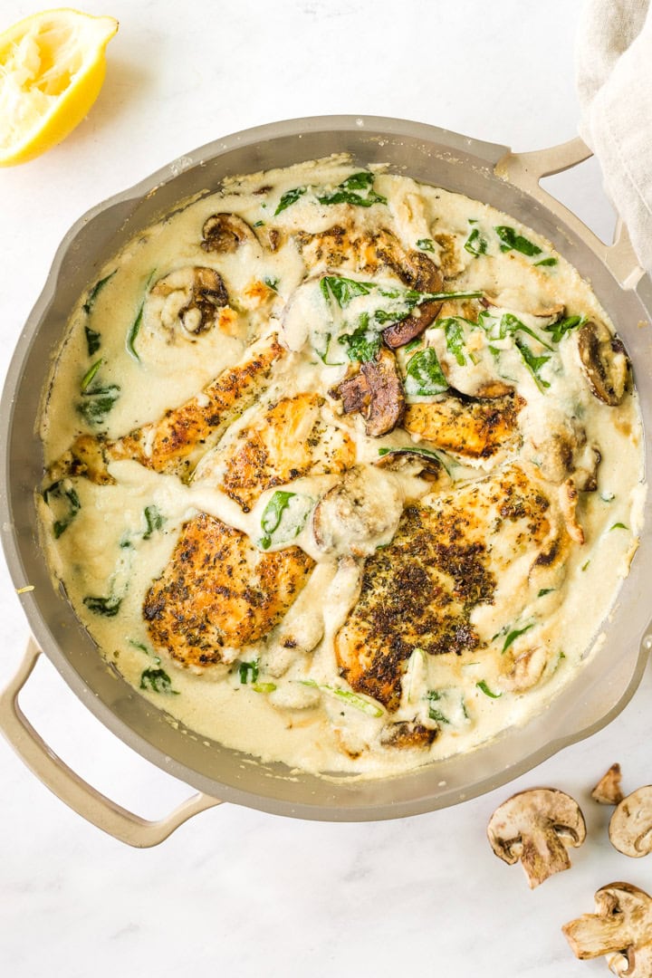 an overhead shot of this healthy Chicken Florentine Skillet recipe in an oven-safe pan Paleo, Dairy-Free, and Whole30