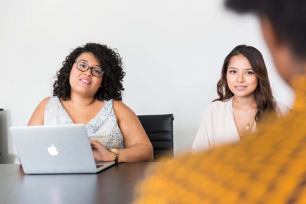 two women looking at person two women looking at person