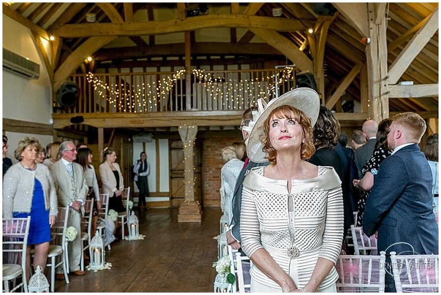A mother waits to see her daughter walk up the aisle on her wedding day at Cain Manor