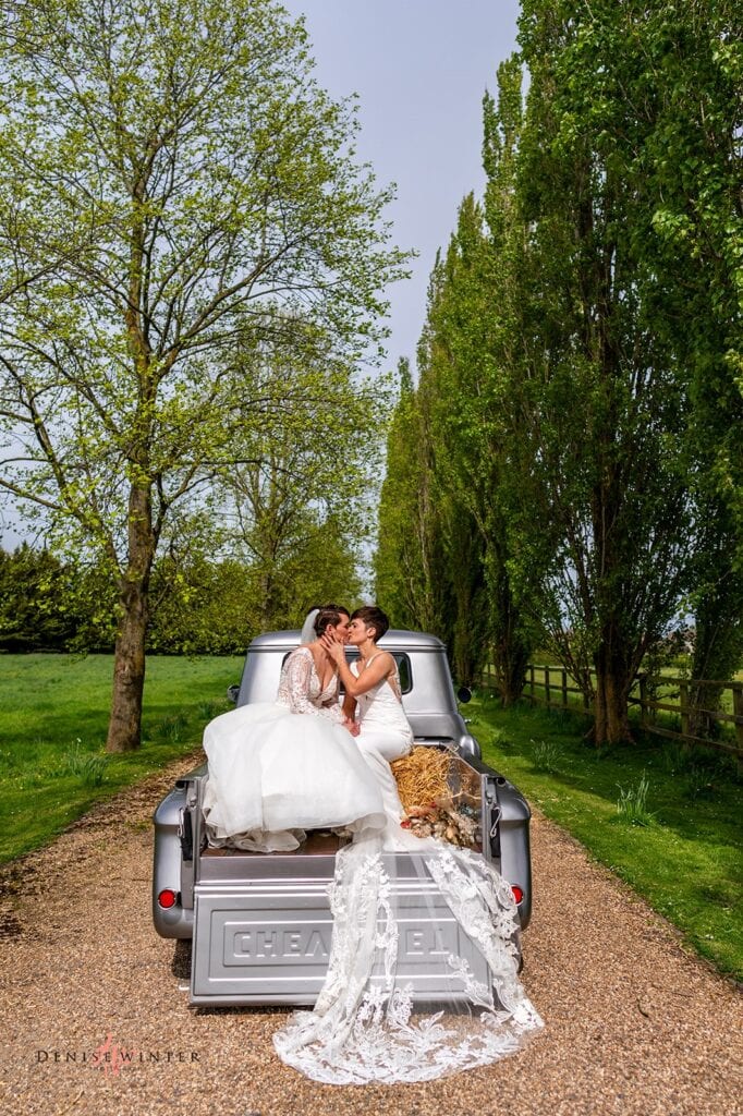Same sex couple pose for wedding photograph at Liullibrooke Manor