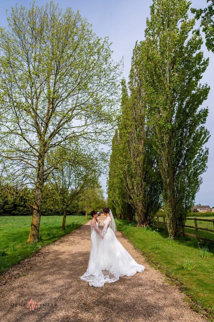 Same sex couple pose for wedding photograph at Liullibrooke Manor