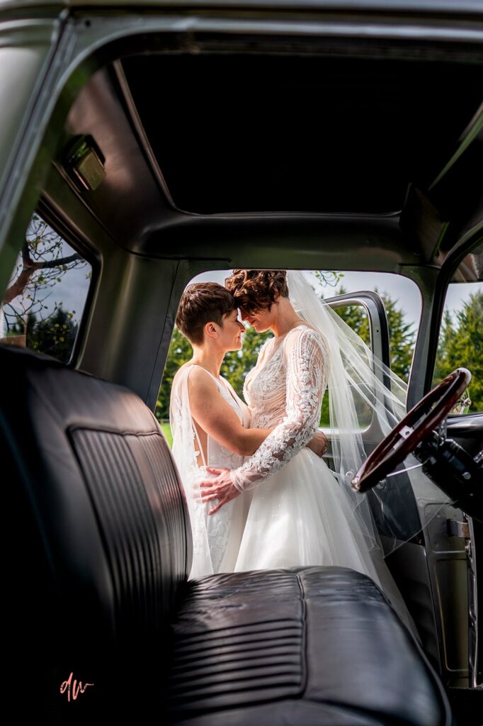 Same sex couple pose for wedding photograph at Liullibrooke Manor