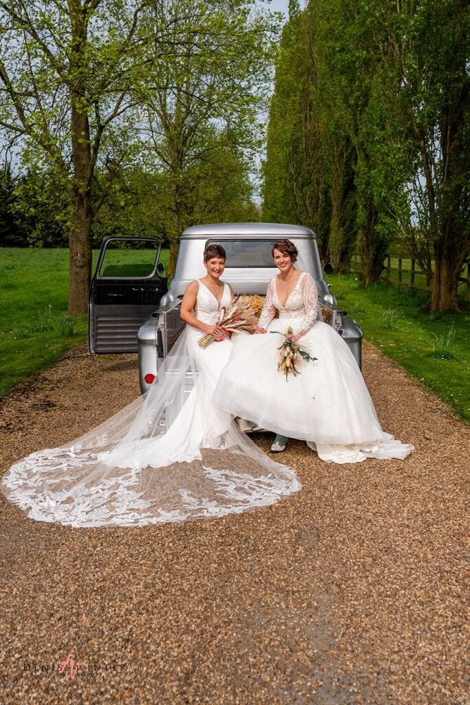 Same sex couple pose for wedding photograph at Liullibrooke Manor