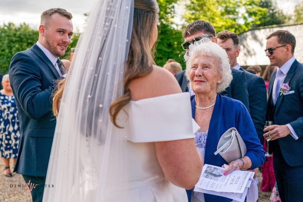 grandma congratulates a bride on her wedding day at wasing park