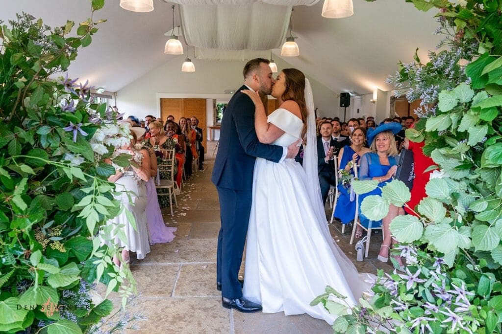 bride and groom first kiss on their wedding day at wasing park