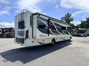 2023 Coachmen Mirada 35OS motorhome in outdoor lot with blue sky.