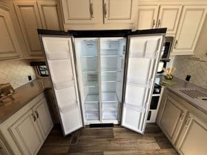 Refrigerator repair service for Keystone Cougar RV in kitchen.