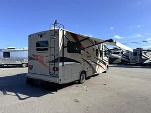 Travel trailer with extended awning at KA RV Repair lot.