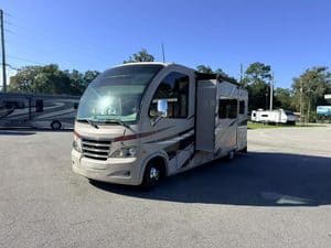 Modern motorhome parked outdoors with slide-out extended.