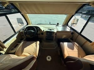 Interior view of RV dashboard and front seats for repair services.