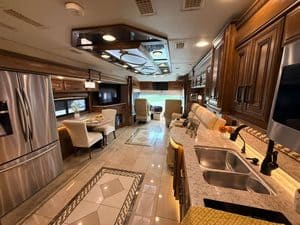 Luxury RV interior with kitchen, seating, and entertainment for 2016 Entegra Cornerstone 45B.