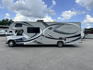 2014 Thor Chateau 28Z Class C RV parked outdoors under blue sky.