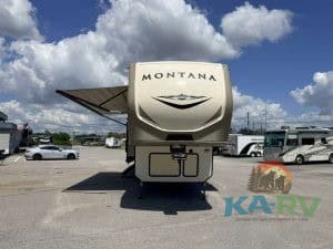 Keystone Montana 3931FB fifth wheel RV parked outdoors under cloudy sky.